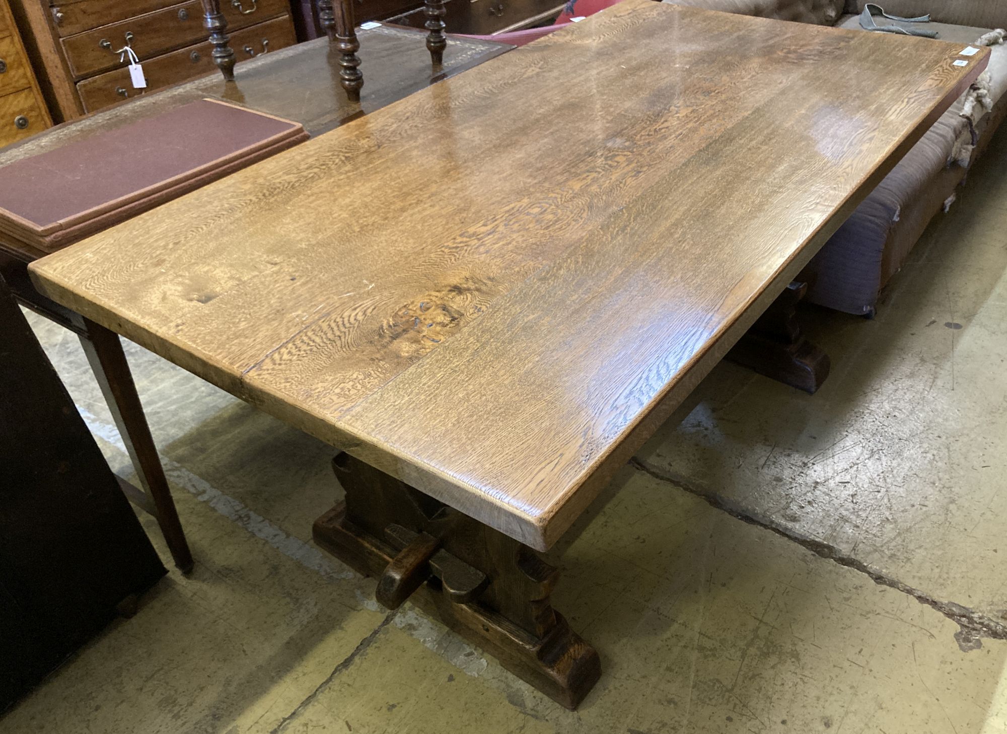 An 18th century style rectangular oak refectory dining table with vase shaped trestle ends, length 168cm, depth 90cm, height 76cm